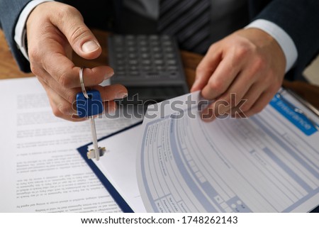 Man in suit prepares document for rental property. Registration home and property insurance policy. Homeowner is housing company. Duty to pay monthly rent on time. Housing system in turn Royalty-Free Stock Photo #1748262143
