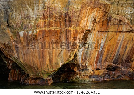 Landscape of mineral stained cliff along the eroded sandstone shoreline of Lake Superior, Pictured Rocks National Lakeshore, Michigan’s Upper Peninsula, USA