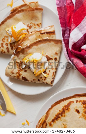 Sweet crape with ricotta cheese. Homemade pancakes with orange filling. Tasty sweet breakfast