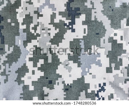 Photo of a military pixel camouflage texture cloth.