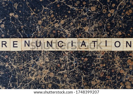  word renunciation from wooden letters in black font on a brown shabby wall with a pattern