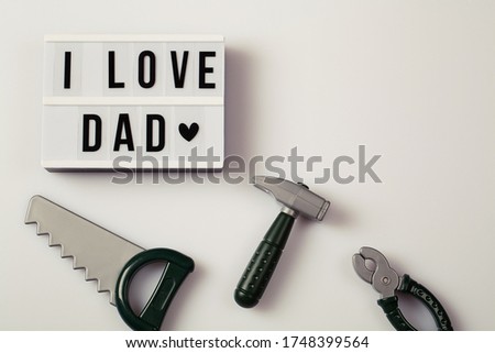 i love dad, Father's Day lightbox message with toy tools for repair saw nippers hammer . top view flat lay copy space