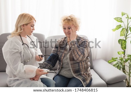 Supportive female nurse visit old grandmother patient at home listen to complains concerns, attentive young woman doctor consulting mature senior grandma, elderly medical healthcare concept
