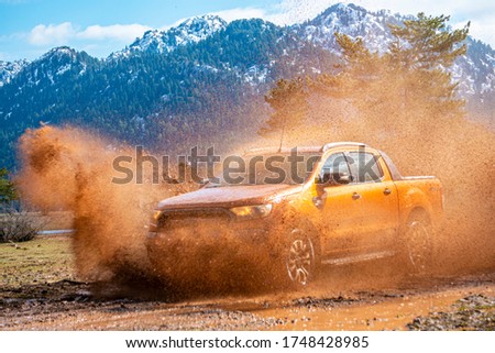pick-up truck is off roading in the mud of the river in the mountains of Antalya Royalty-Free Stock Photo #1748428985