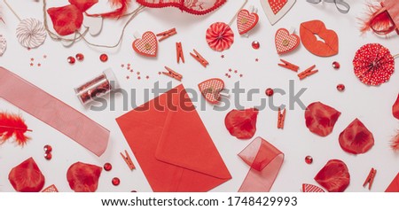 on a white background an envelope and red satin hearts are flying from it
