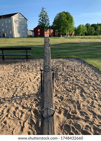 A picture of a seesaw in the sand