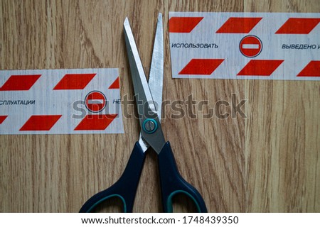 scissors cut a red ribbon