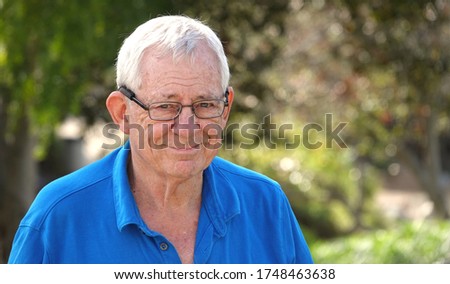 Outdoor portrait of happy, smiling senior man wearing eye glasses                              Royalty-Free Stock Photo #1748463638