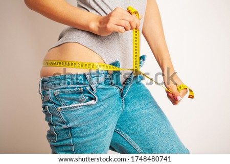 Diet concept, slim woman with measuring tape