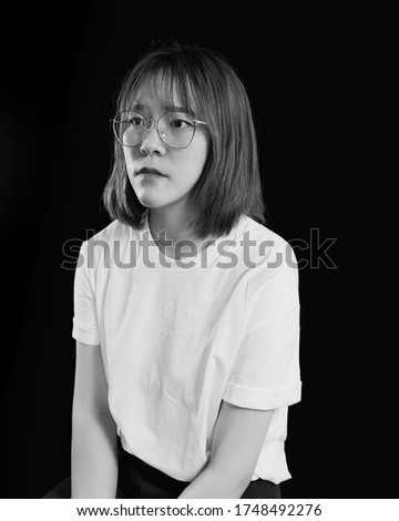 Dramatic emotional portrait of an Asian girl in studio, Photo in black and white.