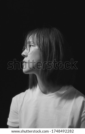 Dramatic emotional portrait of an Asian girl in studio, Photo in black and white.