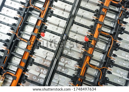 Selective focus of Electric car lithium battery pack and wiring connections internal between cells on background. Royalty-Free Stock Photo #1748497634