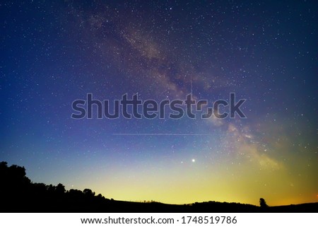 Summer Milky Way and satellites in the night sky.