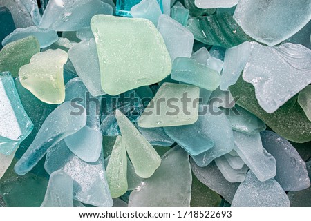Sea Glass Mosaic, patterns made from Ocean glass, its a lifestyle background made with natural colours of blue, green, brown and white, hand made feeling like handcraft. Royalty-Free Stock Photo #1748522693