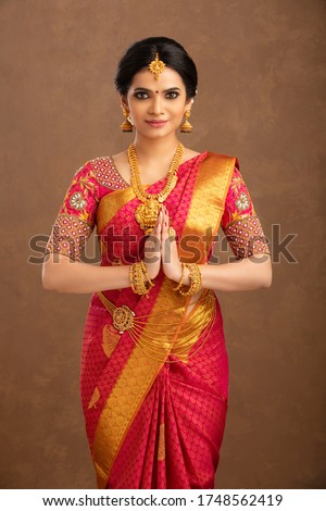 Beautiful Indian bridal greeting in studio shot. Royalty-Free Stock Photo #1748562419