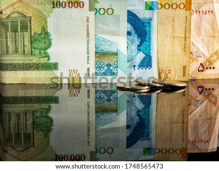 Iranian Rial (IRR). Close-up detail of banknotes and coin.  Top view.