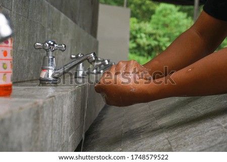 Image of a man washing his hands with soap to prevent corona virus. Hand wash step