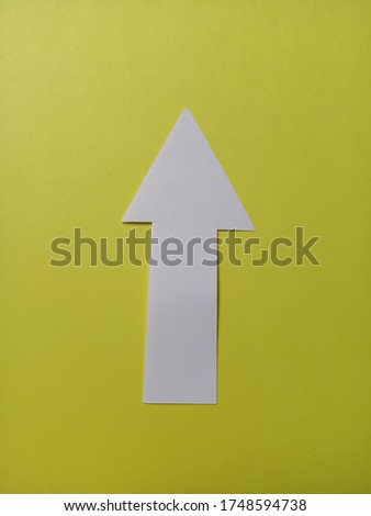 White plane arrow on clear yellow background surface without any marks or printed
