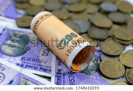 Indian currency Note of  Two hundred rupees banknote with 5 rupee coin of India with a denomination of 100 200. concept image for various type of monetary transactions Royalty-Free Stock Photo #1748610293