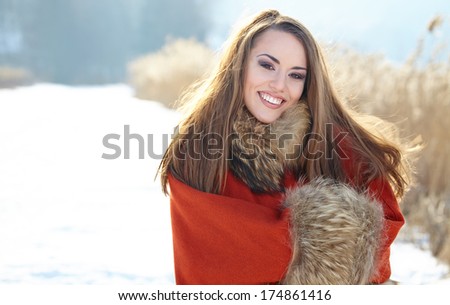 beautiful girl freezing in winter park. pictures in warm colors 