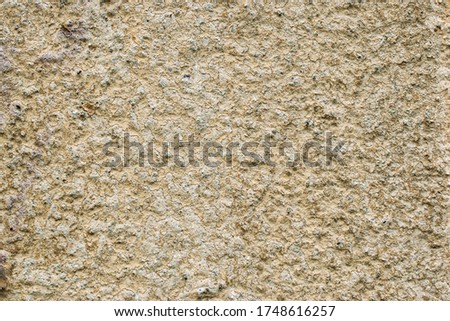 Textured beige putty wall. Rough background, surface with bulges