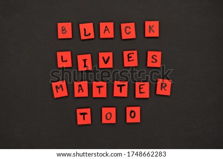inscription black lives matter too. protest signs. lettering. red letters on wooden squares on a black background. I can t breathe.