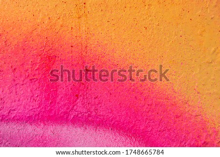Beautiful bright colorful street art graffiti background. Abstract creative spray drawing fashion colors on the walls of the city. Urban Culture, orange , pink , purple , crimson, blue texture Royalty-Free Stock Photo #1748665784