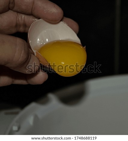 Picture of pouring egg yolk to mixer bowl. Selective focus.