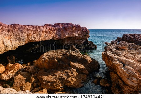 the rocks on the seashore at sunset