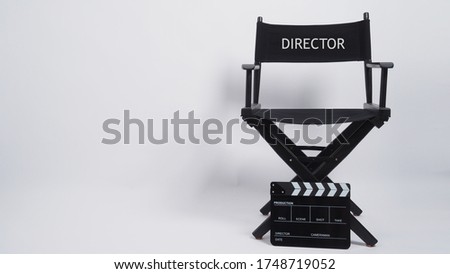 Director chair and Clapper board or movie slate use in video production or movie and cinema industry. It's black color. Royalty-Free Stock Photo #1748719052