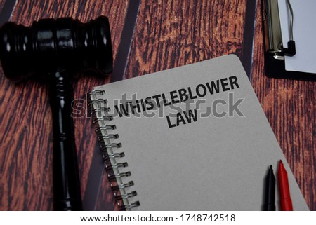 Book about Whistleblower Law isolated on wooden table.