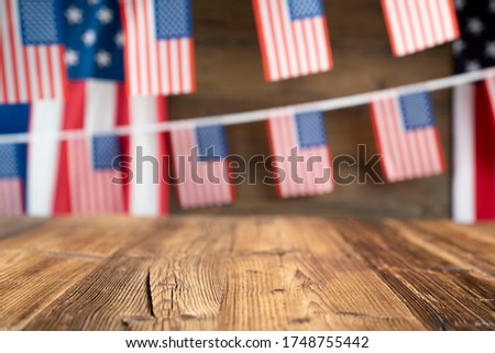4th of july celebration. American flag and decorations. Burgers on rustic wooden table. 