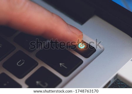 Closeup of Man's Finger Touching the Letter Power Key on Black Computer Keyboard