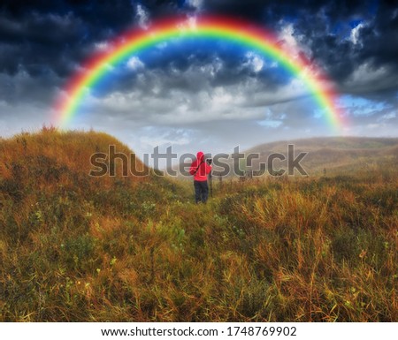 
Woman Looking At Rainbow. At moment of wonderful
