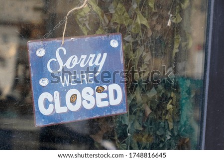 sorry we are closed sign board on windows shop restaurant cafe store signboard