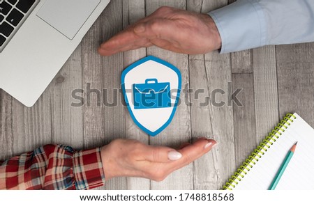 Concept of job loss insurance with hands in a protective gesture Royalty-Free Stock Photo #1748818568