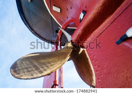 Vintage Steam Tug Brass Propeller Vessel Mounted dry-docked old steam tug boat vessel with solid brass propeller and riveted hull metal plates visible in its construction early 1950's