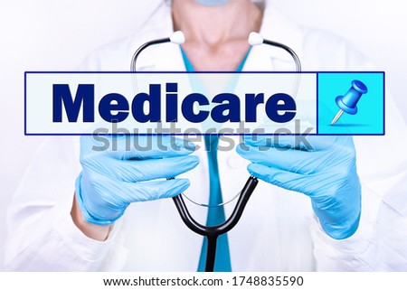 MEDICARE text is written on the background of a doctor holding a stethoscope. Medical concept. Royalty-Free Stock Photo #1748835590