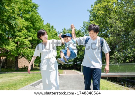 Family walking holding hands under the blue sky Royalty-Free Stock Photo #1748840564