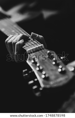 Women's hands play the guitar