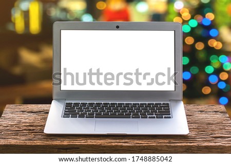 laptop or notebook with blank copy space for your text on wooden mock up over blurred bokeh background for advertisement showcase or advertising marketing concept. 
