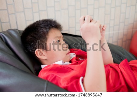 asian chinese boy playing smartphone, kid use phone and play game, addicted game and cartoon, 

