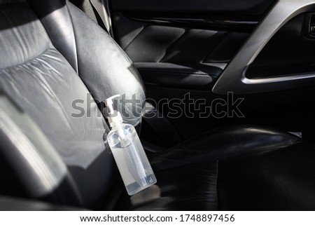 Hand sanitizer placed on car seat and exposed to sun in sunny day,do not keep alcohol antiseptic gel in the car,could start a fire,flammable objects,cause danger if parked in the sunshine,very hot day Royalty-Free Stock Photo #1748897456