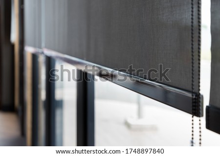 blind curtain or black blinds Roller sun protection in office. Royalty-Free Stock Photo #1748897840