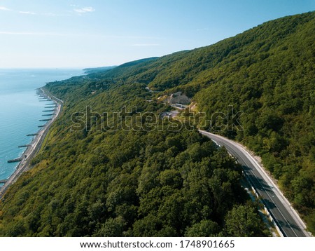 Mountain winding zig zag highway road. Top aerial view: cars driving on road from above.