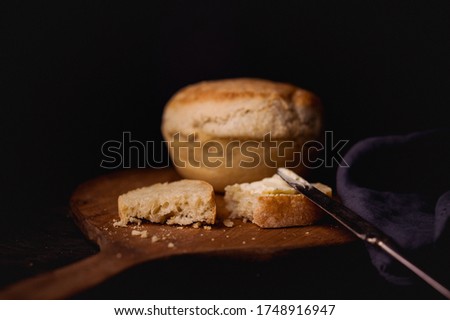 Fresh homemade bread on a wooden cutting board.