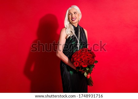 Photo of attractive retired white haired lady luxury rich person movie star hold big bunch roses fans present red carpet wear shiny long glossy fashion dress isolated vivid color background