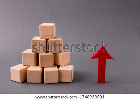 Photo of pile stack wooden cubes market supply sales growing rising raising red arrow pointing up income money progress profit isolated over dark pastel grey color background