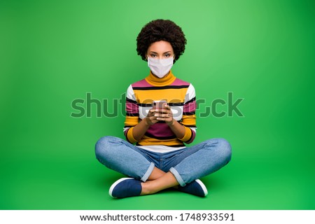 Portrait of her she nice healthy girl wearing safety mask preventive gear sitting lotus pose using gadget viral respiratory pneumonia mers cov ncov-2 prevention isolated green color background