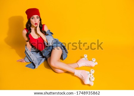 Top above high angle view full length photo surprised youth girl sit floor roller skater ride impressed touch hands face scream wear red singlet jeans isolated bright color background